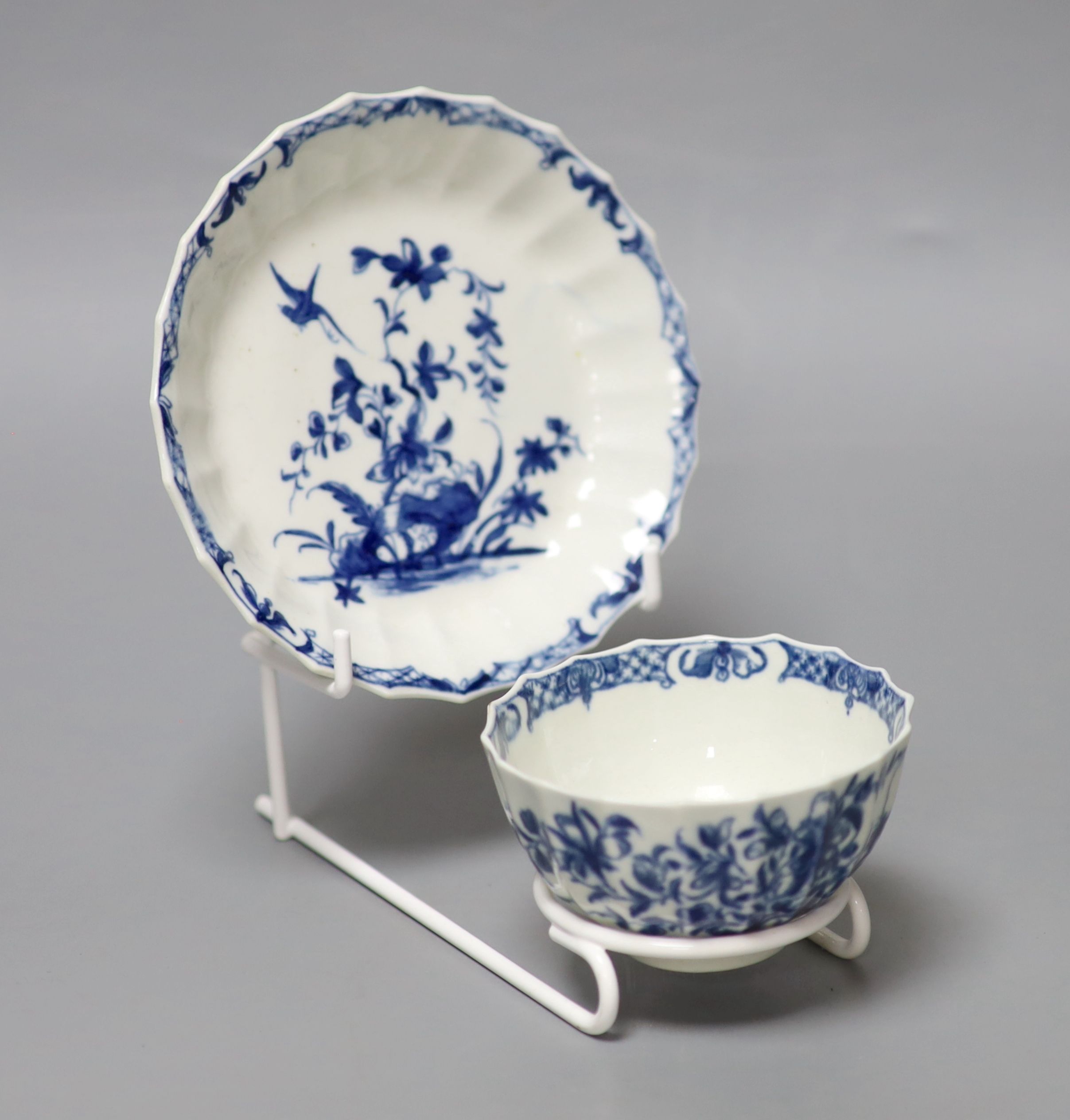 An 18th century Worcester tea bowl and saucer painted with the Hollow Rock Lily pattern, crescent marks